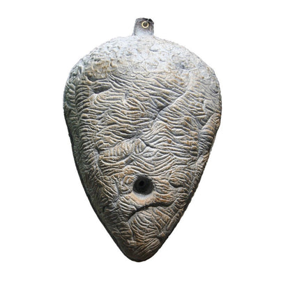 Fake wasp nest deterrent hanging outdoors to repel wasps naturally without chemicals
